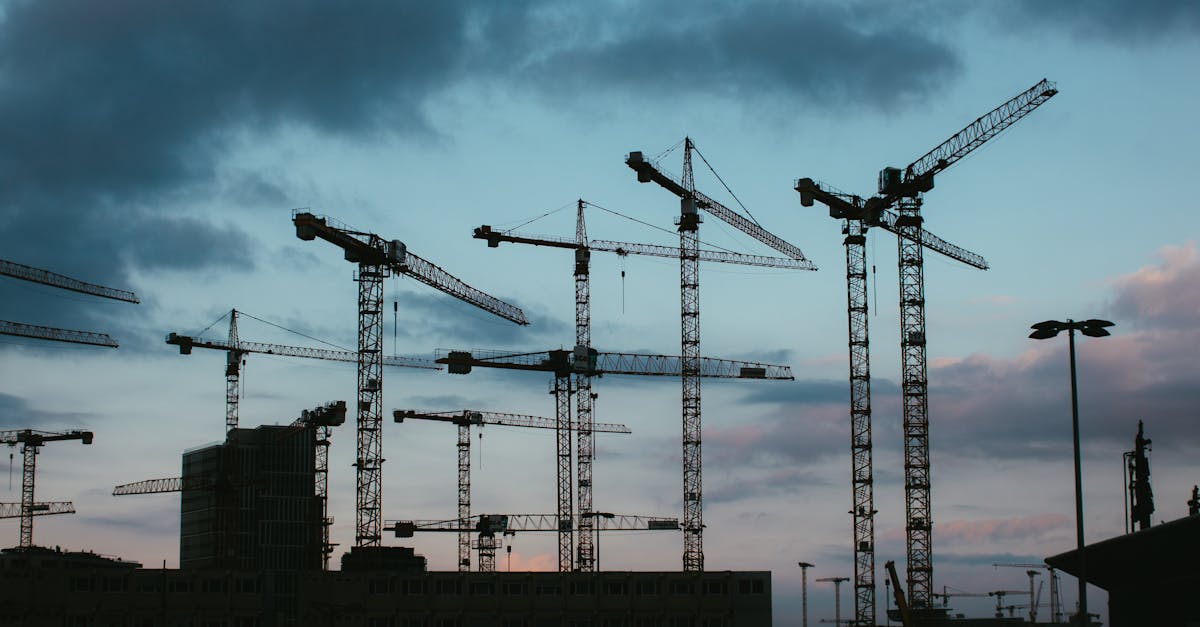modern Warsaw skyline with construction cranes and data graphs overlay