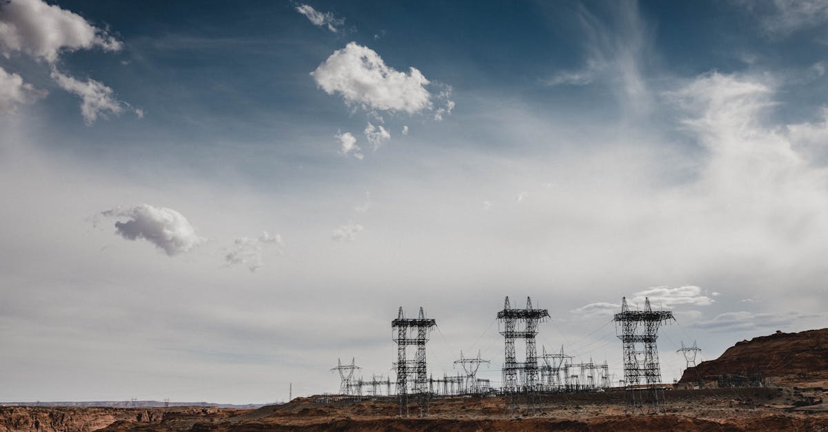 data center cooling towers under desert sky with power lines