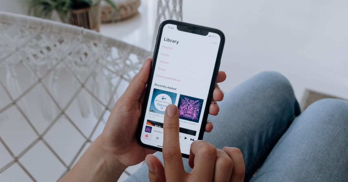 person editing music playlist on smartphone