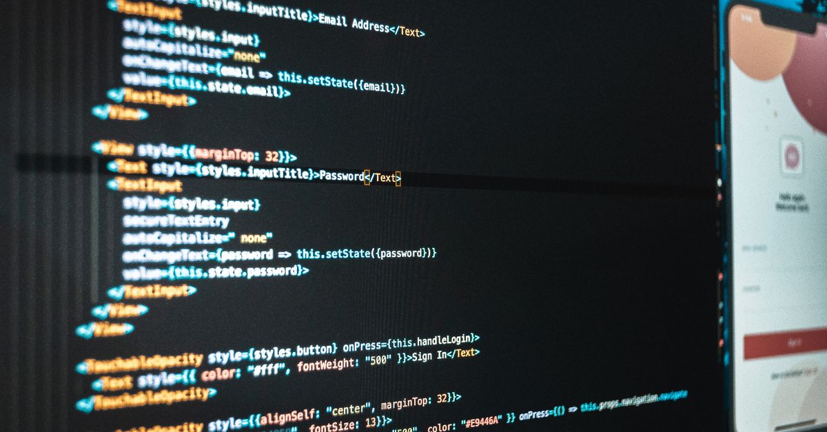 laptop screen showing code, an email newsletter preview, and a financial graph