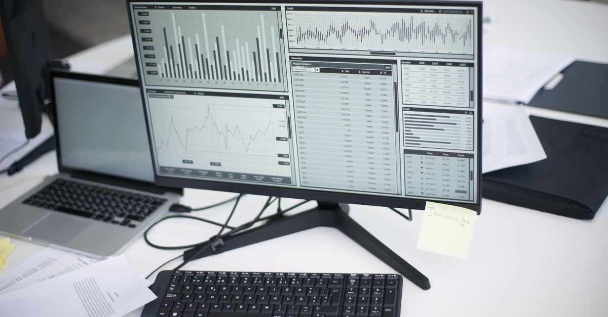 modern office desk with Linux desktop screen and data charts