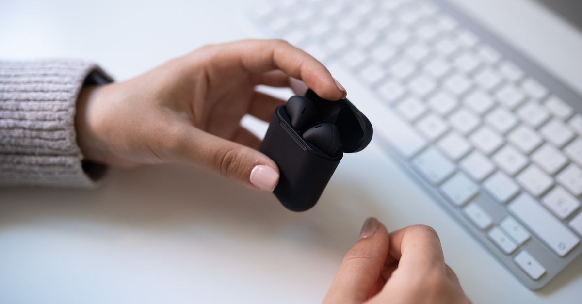 close-up of true wireless earbuds in a modern office setting
