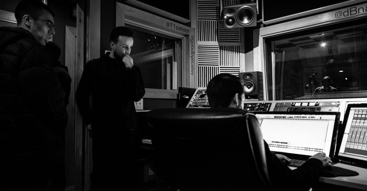 studio engineers reviewing render queue on multiple monitors