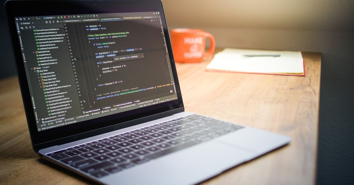 developer laptop with macOS installer window on screen