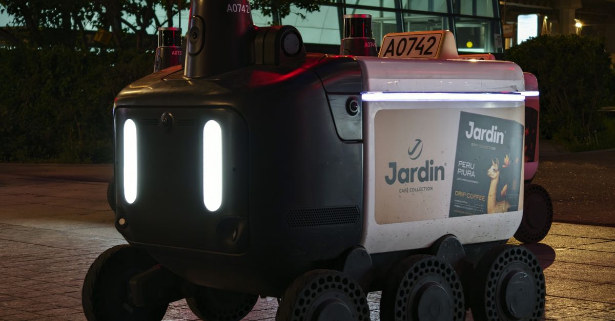 robotic car on city street with teenage passengers