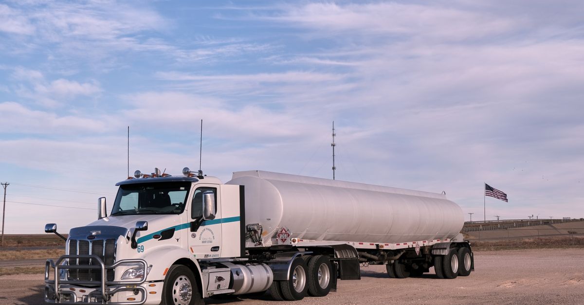 diesel tanker beside a semi truck on a highway