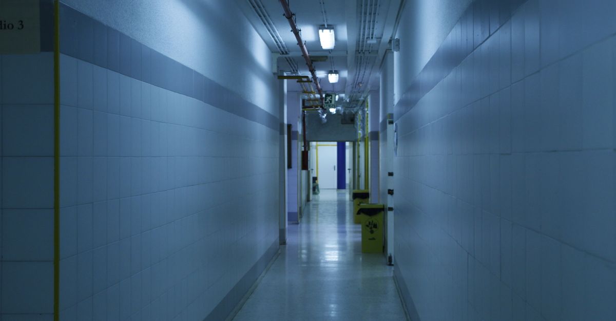 office hallway with empty desks and a dimly lit AI server rack