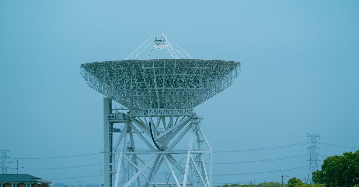 satellite dish over city skyline with data streams