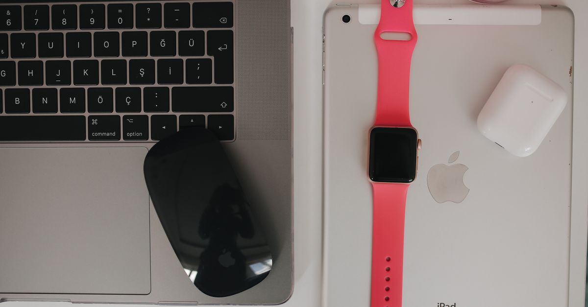 a sleek smartwatch beside a digital blueprint on a tablet