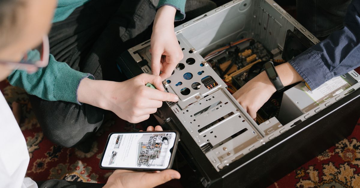 budget Android phone on a workbench with a GPU and hard drives