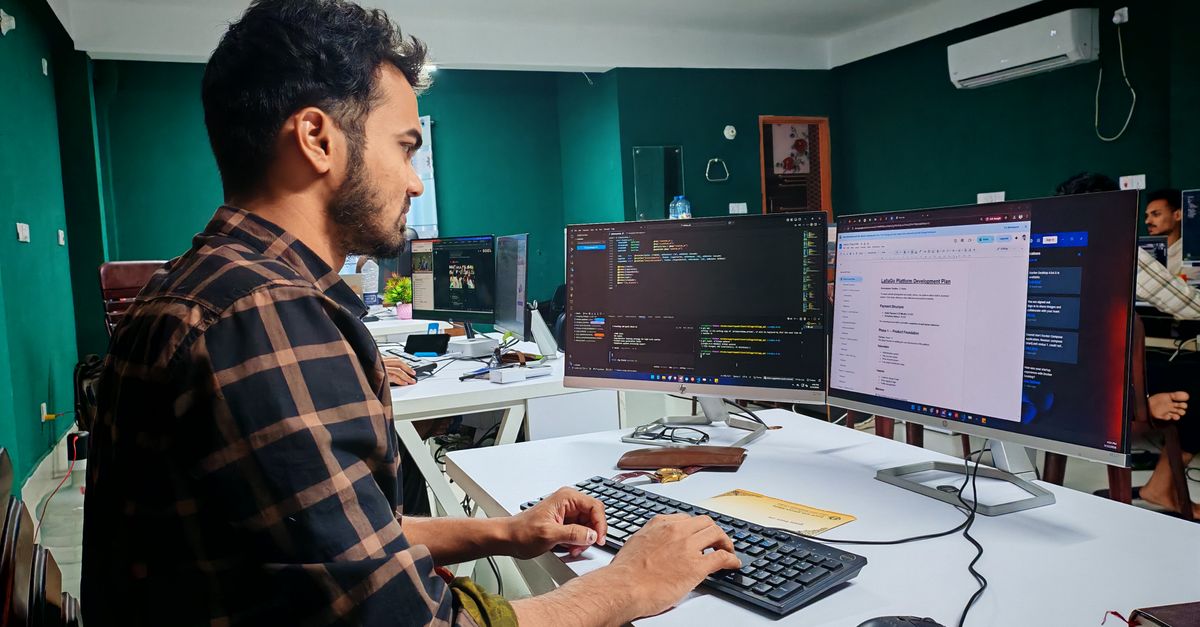 dual-screen developer workspace with code and snowflake motif