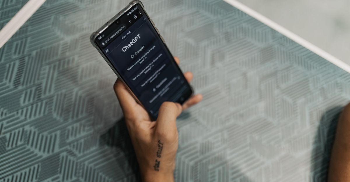 person using a smartphone with AI assistant notifications on screen