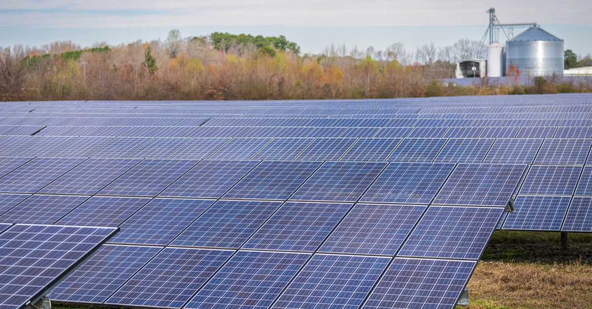 data center with solar panels and coal plant contrast